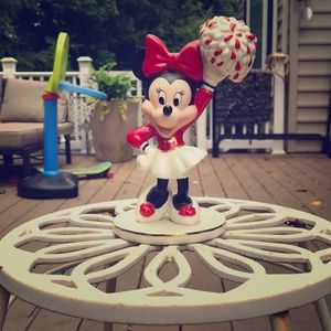 A antique Minnie mouse cheerleading figurine
